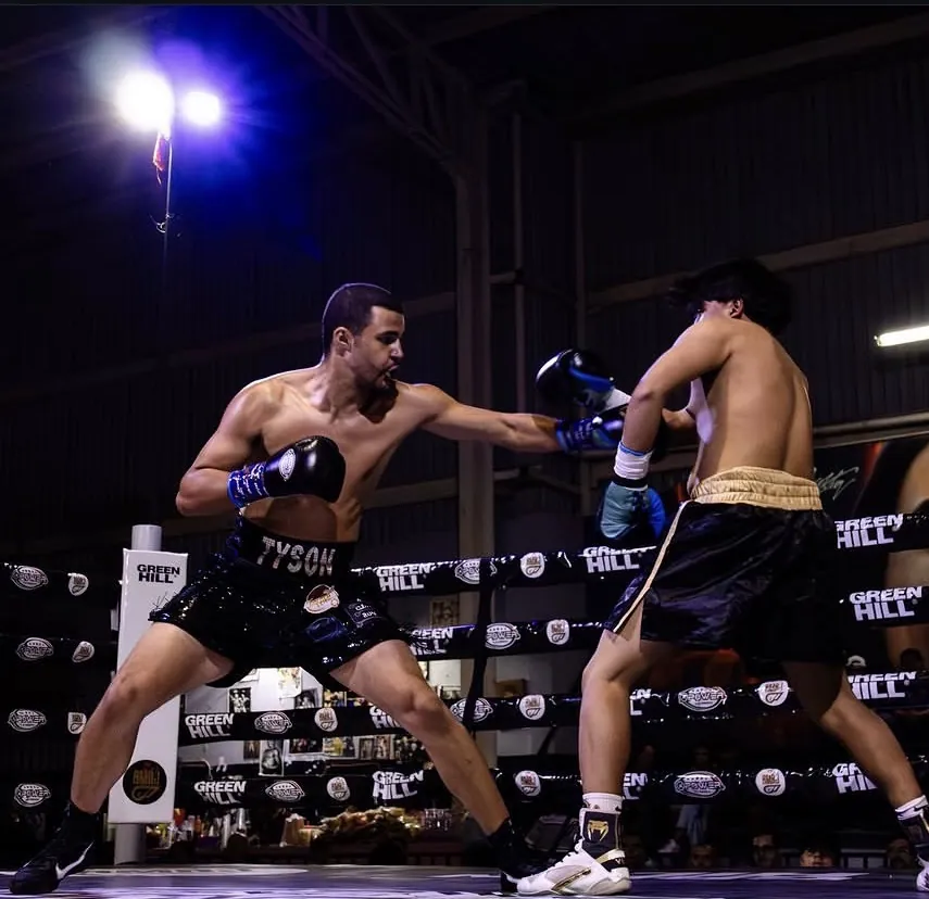 Tyson Isa landing a straight punch during a professional bout.