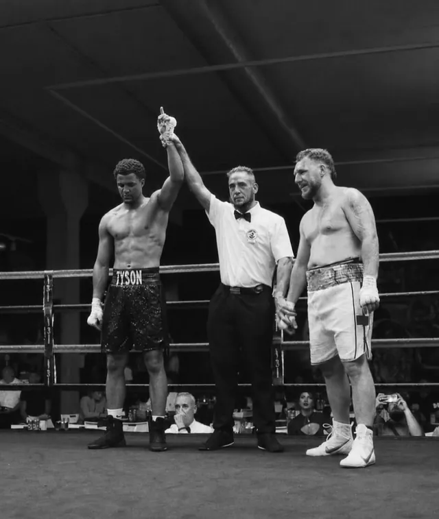 Referee raising Tyson Isa's hand after a professional victory.